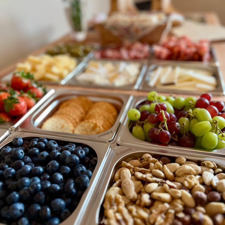 A selection of charcuterie foods inside the Le Petit Chariot luxury grazing cart A selection of fruits, nuts, cheeses, and charcuterie meats arranged on the Le Petit Chariot luxury grazing cart, ready for a wedding.